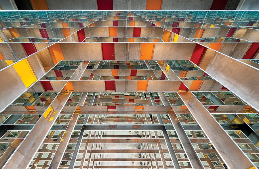 In the Danish university city of Aarhus, the Grundfos Dormitory by CEBRA encases a 12-storey atrium with mirror-clad balconies, creating drama with an economy of means. Mikkel Frost