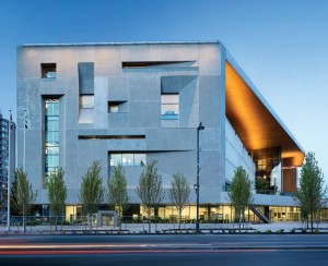 Sculpted openings adorn the west facade, which continues the street edge formed by Bing Thom's neighbouring library.