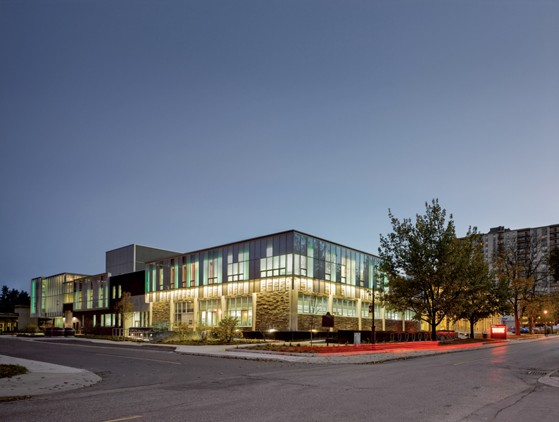 A rhythmic use of curtain wall ties together the existing building and new addition.