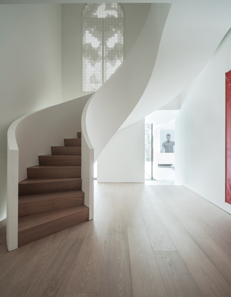 The stair is a stunning focal point in the enlarged foyer.
