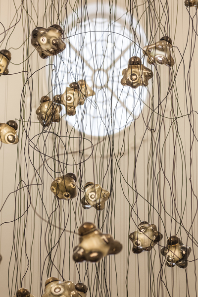 A suspended array of smoky bulbous glass lights lends a playful yet elegant touch to the renowned Mallet Antiques showroom in London. Photo by Gwanael Lewis