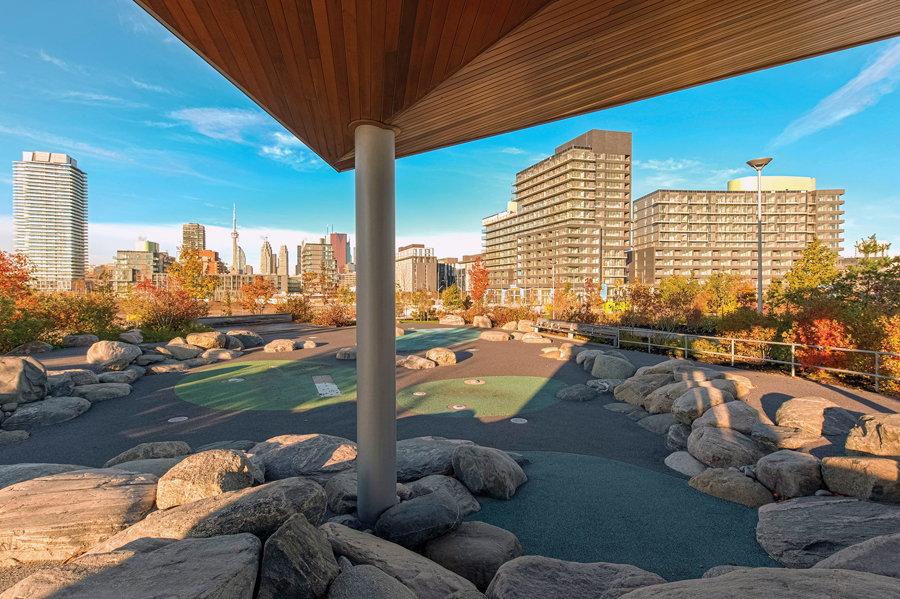 The curved faade of Block 4 condominiums forms a clear edge to the park known as Corktown Common. Photo by Brent Wagler.