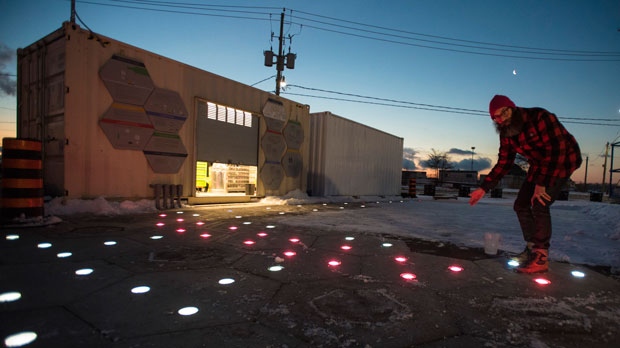 Jesse Shapins, Director of Public Realm, Sidewalk Labs, discusses the modular pavement that feature lighting, selective heating and porous slabs designed to soak up water into a stormwater management system, during a media preview of Open Sidewalk - Winter Warmer in Toronto on Friday, March 1, 2019. (THE CANADIAN PRESS/ Tijana Marti