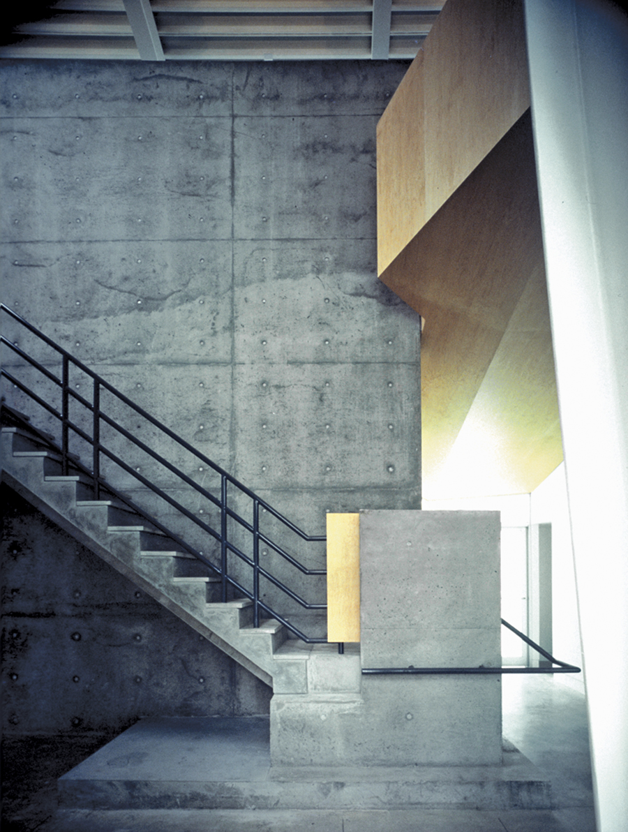 Exposed painted steel, grey brick and concrete comprise a sober material palette for the gallery building. Peter Cardew Architects