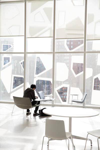 Areas of clear glass offer views of the downtown cityscape