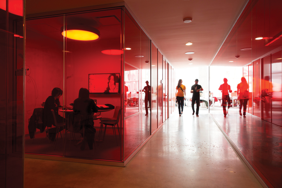 The fifth floor features study rooms encased in translucent red panels