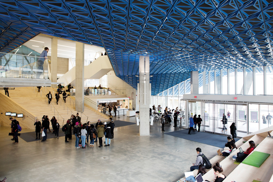 The triple-height atrium is ringed with bleacher-like seating ideal for people-watching with a coffee and a laptop.