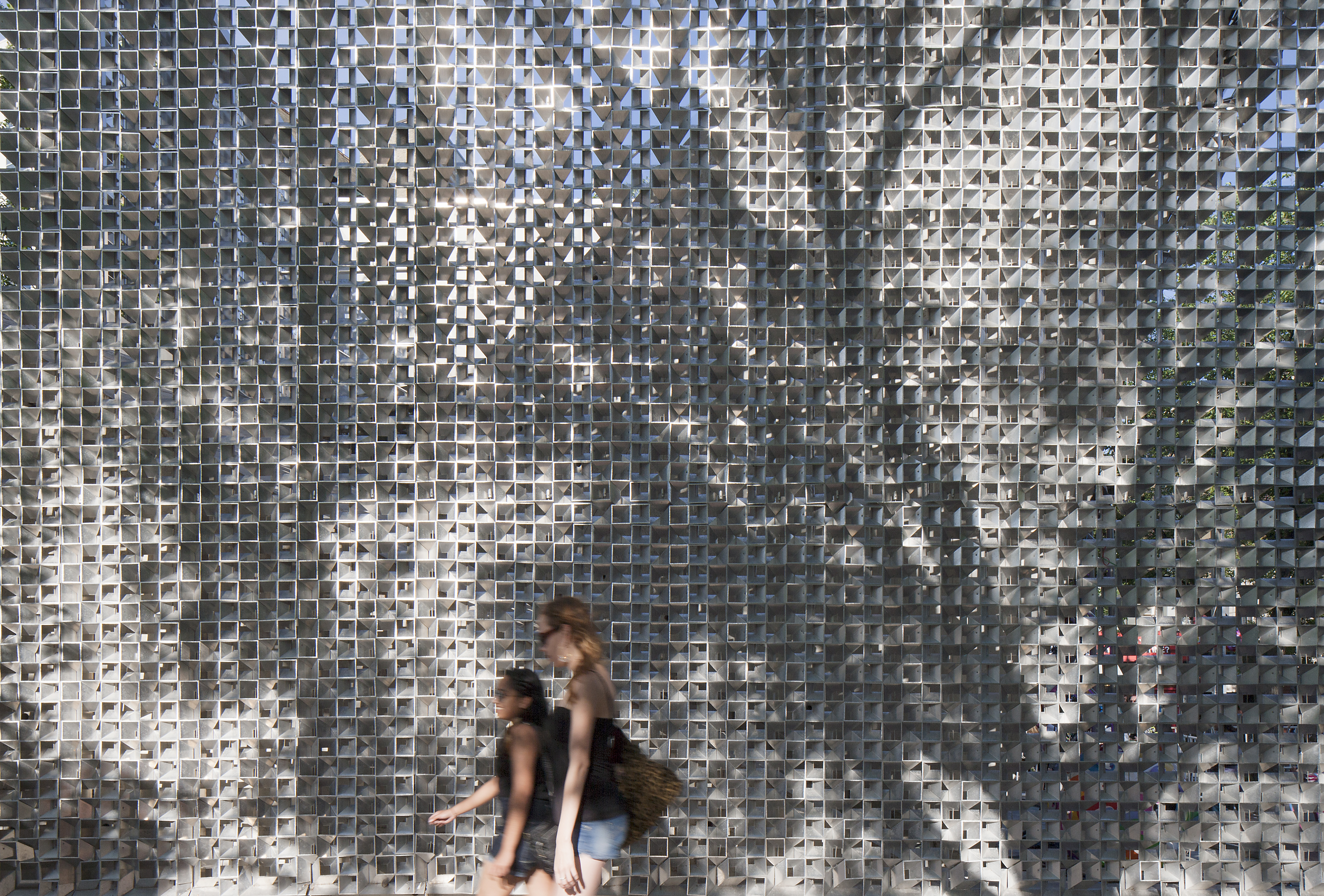 Light and shadow play across the screen wrapping the OMS Stage. Photo by James Brittain.