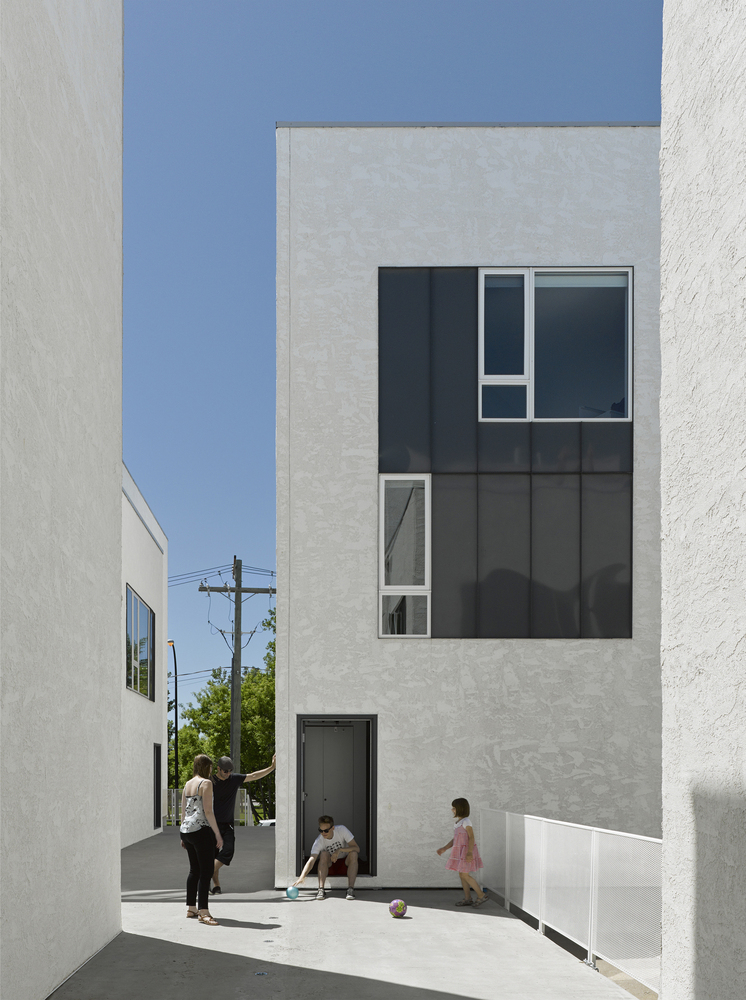 Seeking variation from typical townhouses, You Cube includes an elevated walkway that acts as a semi-public realm.