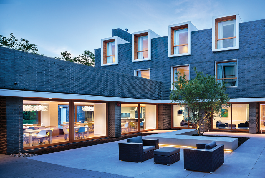 The design includes generous outdoor and indoor common areas, composed in a mature contemporary aesthetic. Dormer assemblies for the apartments were pre-fabricated off-site and dropped in by crane. (Photo: Ed White)