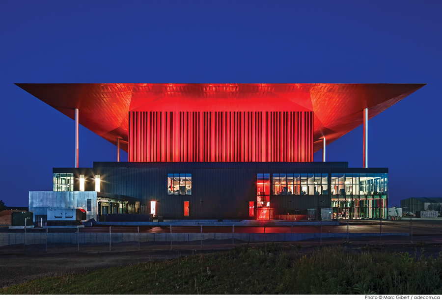 The fly tower’s aluminum cladding is carefully composed into a striated pattern with three shades of red.