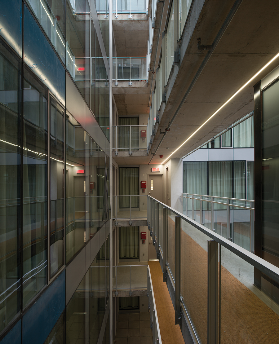 The upper floor rental units are accessed from exterior walkways.