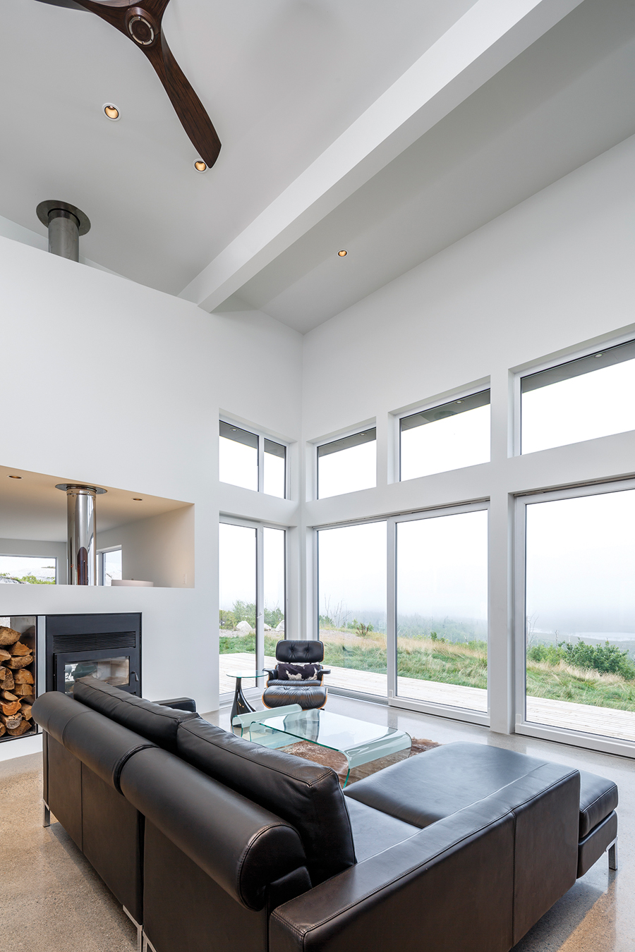 The living room enjoys a panoramic view of an inland lake.