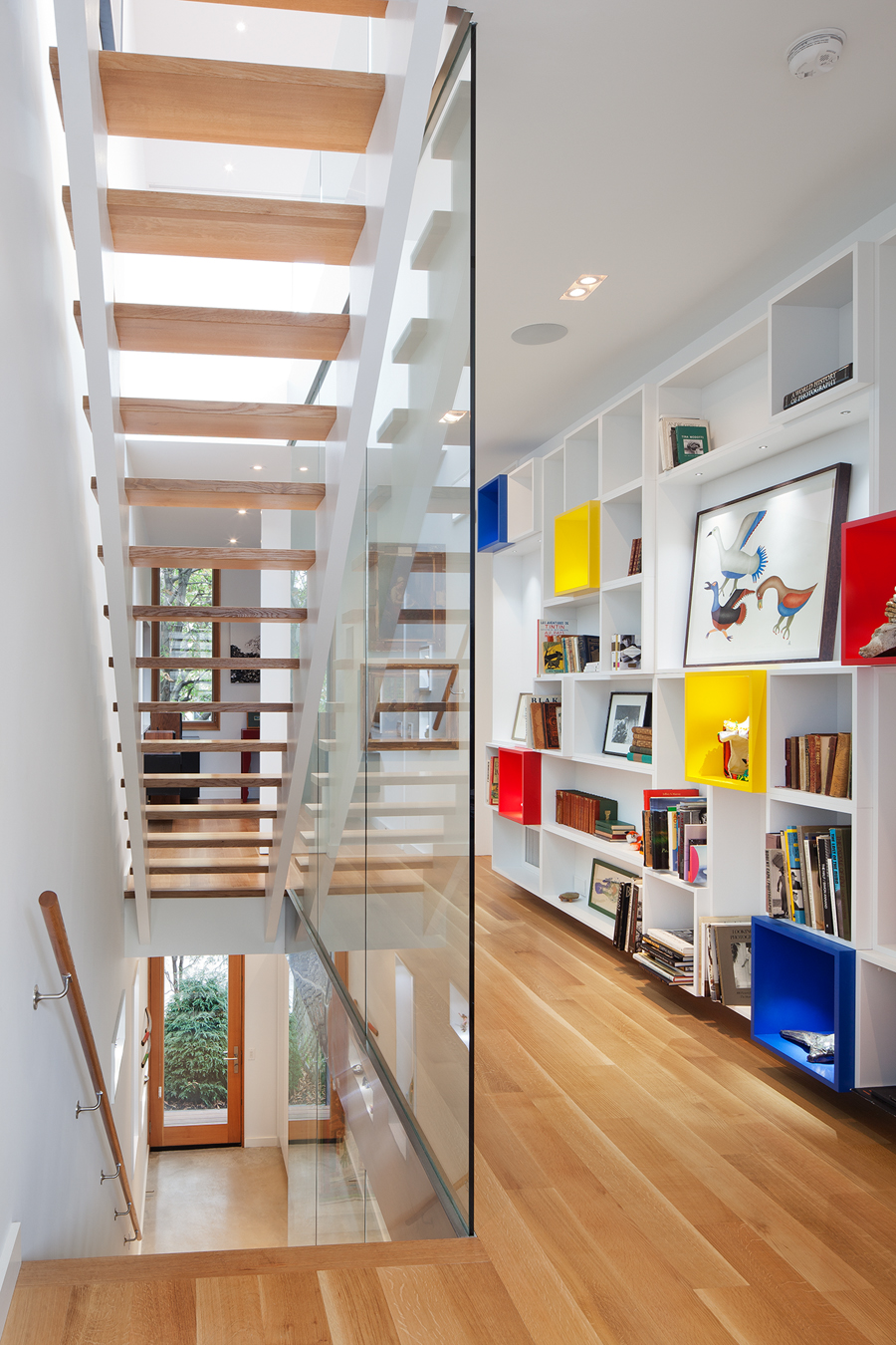 A custom, modular bookcase system enlivens the second floor of House 2.