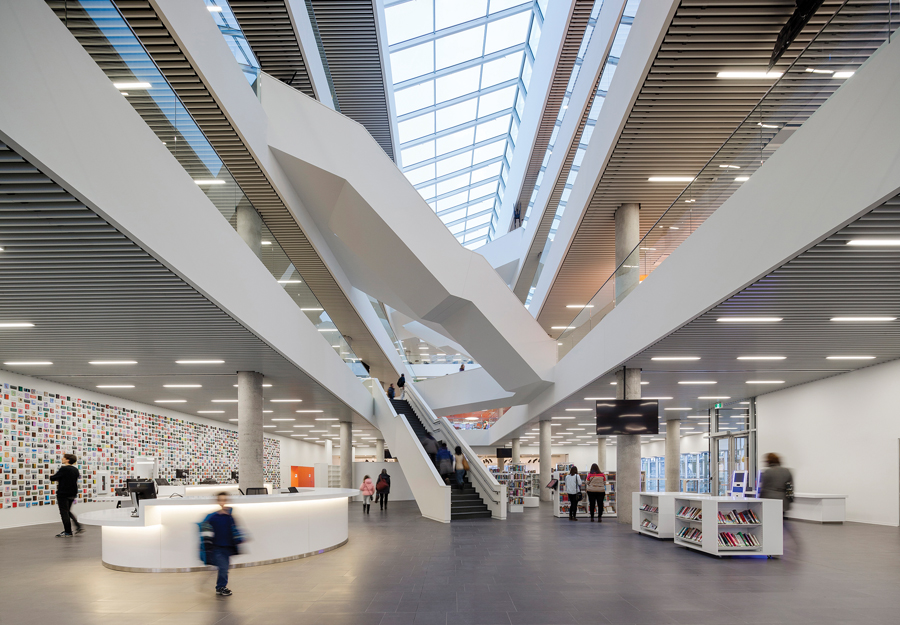 Stairways playfully criss-cross through the skylit atrium of the library. Different types of gathering places are interwoven in the plan, including a large theatre, study areas, storytelling spaces and a lounge-style reading room on the top floor.