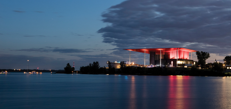 View of the amphitheatre reflected in the St. Lawrence River at night. Photo by Adrien Williams.