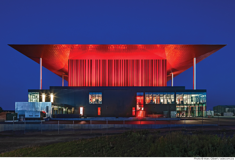 A tapered red roof and aluminum-clad fly tower give the amphitheatre an iconic presence in Trois-Rivières.