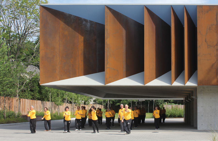 The open space underneath the building contributes to the required parking area for the facility, doubling as a sheltered outdoor area for community activities.