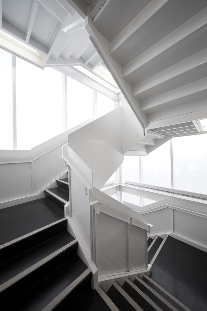 A folded steel-plate stair ascends to an observatory, adding a vertical dimension to the project.
