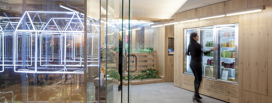 3-D neon logos in mirrored boxes create artful reflections in a Greenhouse Juice Co. location for an underground shopping concourse. Photo by Scott Norsworthy