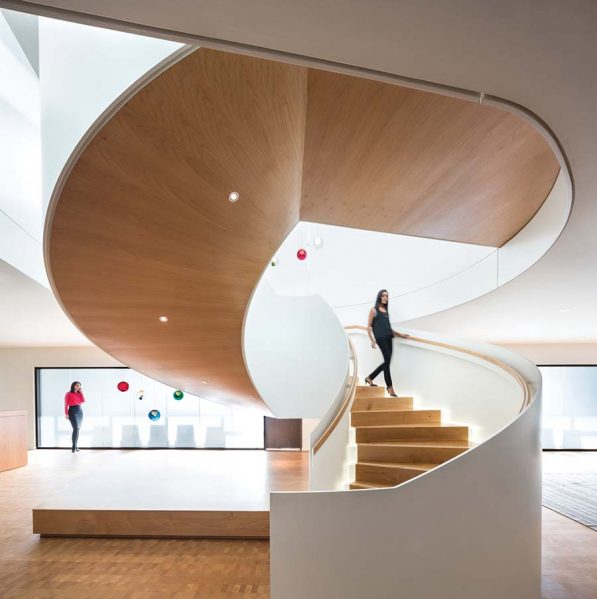 An elegant spiral stair connects two floors of the TELUS offices as part of the interior fit-out designed by omb. Glass lights by Canadian designer Omer Arbel add sparkle to the space. Photo by Ema Peter