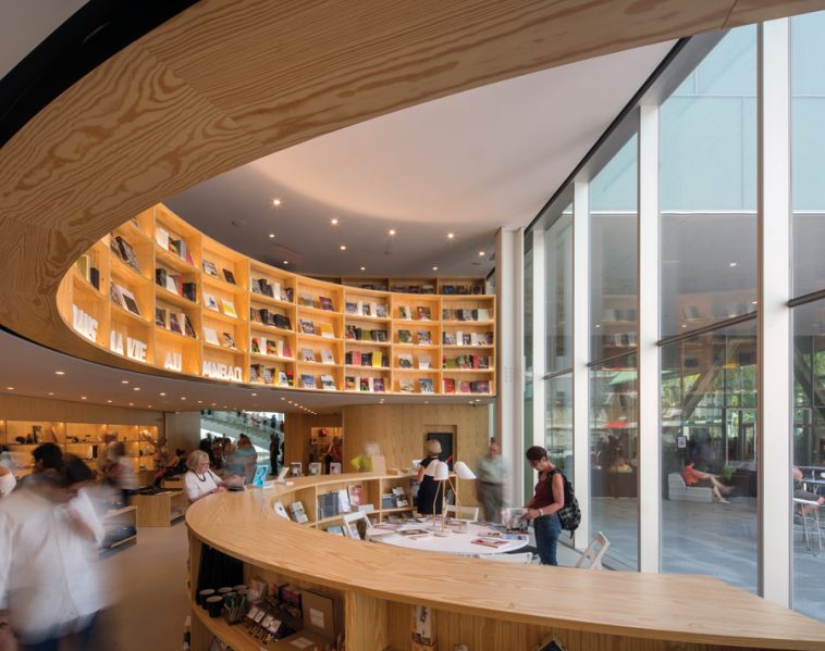 A wood-clad bookstore faces a courtyard framed by the presbytery and former convent buildings. Photo by Nic Lehoux