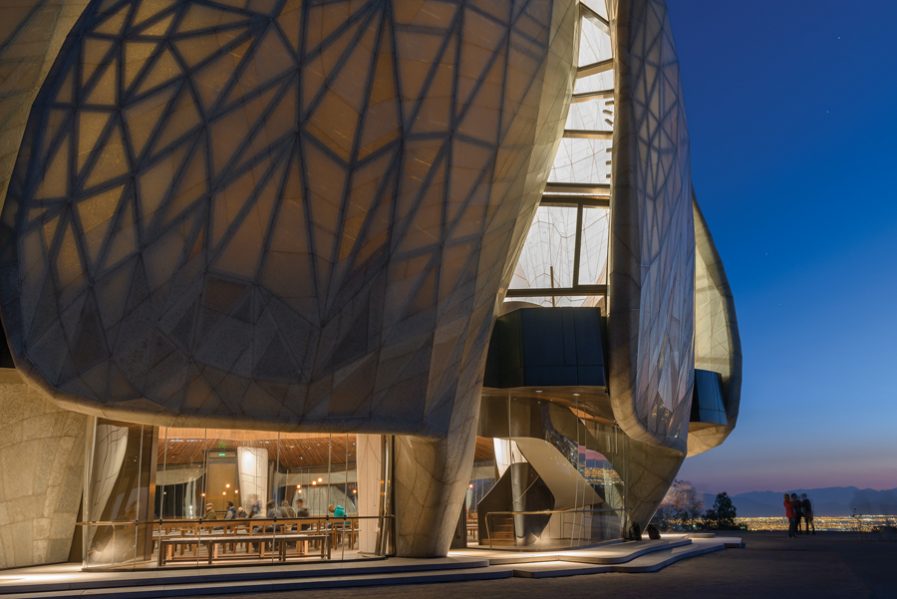 At dusk, the luminous façade beckons visitors. The exterior skin is composed of custom cast-glass panels set on an intricate steel structure, while the interior skin is made of exceptionally white Portuguese marble slabs. Photo: Sebastián Wilson