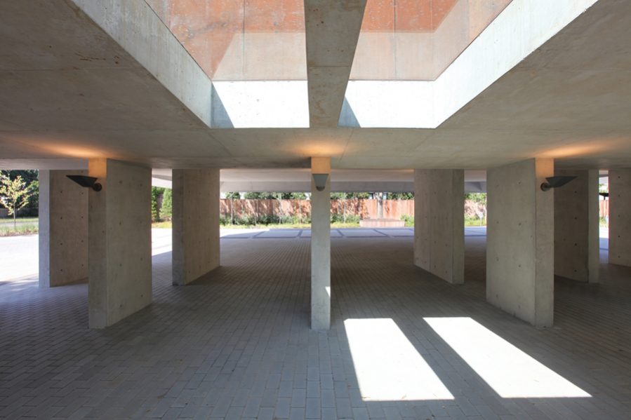 The sacred space sits on a two-way concrete slab integrated with slender piers, tied to a robust raft foundation.