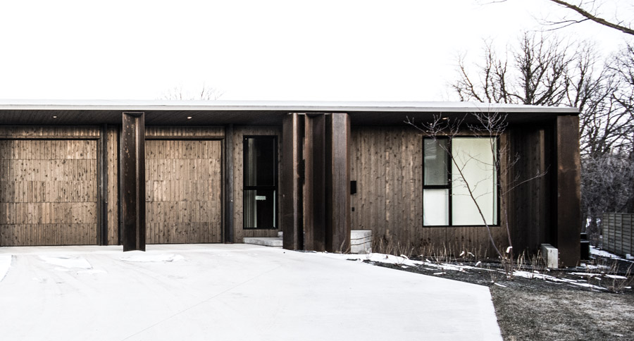 Appearing as a modest bungalow, the house takes advantage of its geometry to accommodate a three-car garage on one side, and expansive views on the opposite side.