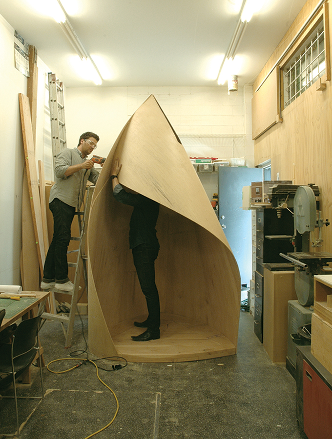 Staff at Patkau Architects assemble a full-scale mockup of a skating shelter at the back of the firm's office in Vancouver