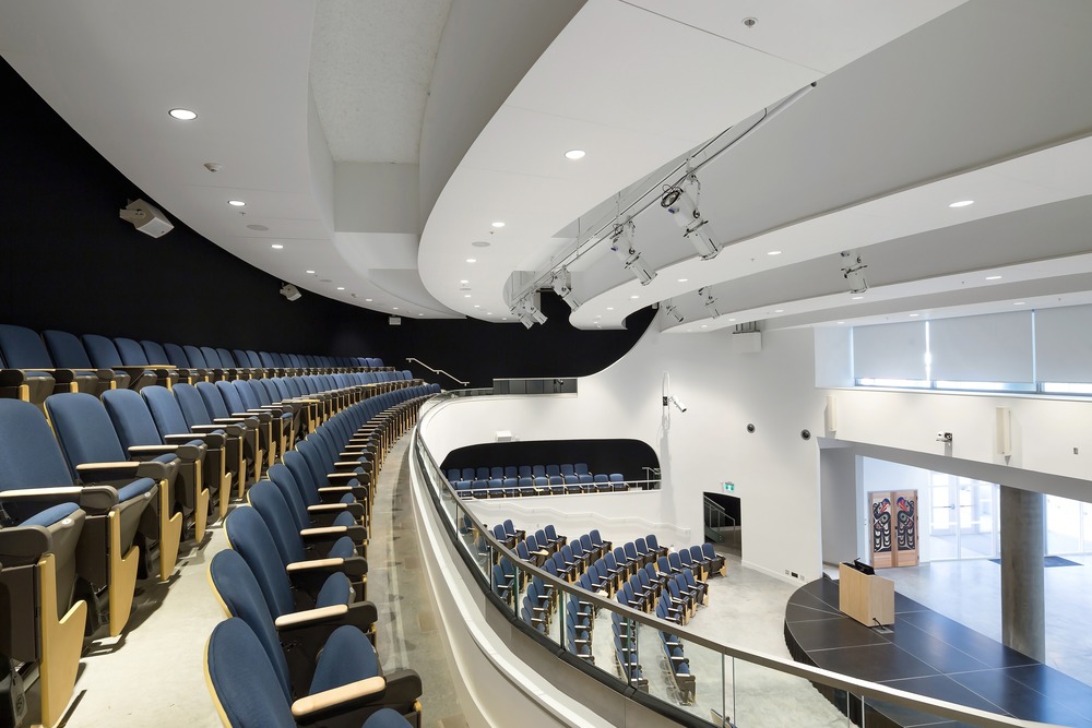 Emily Carr - Recessed dimmable downlights and RGBW-DMX theatrical luminaires provides flexible lighting for the multipurpose theatre through DMX controls. Photo credit: Silent Sama