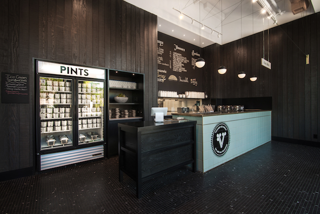 With subtle retro influences, McKinley Burkart settled on a restrained palette of simple, unassuming materials like wood panelling and black marble tile for the third instalment of the Village Ice Cream brand.