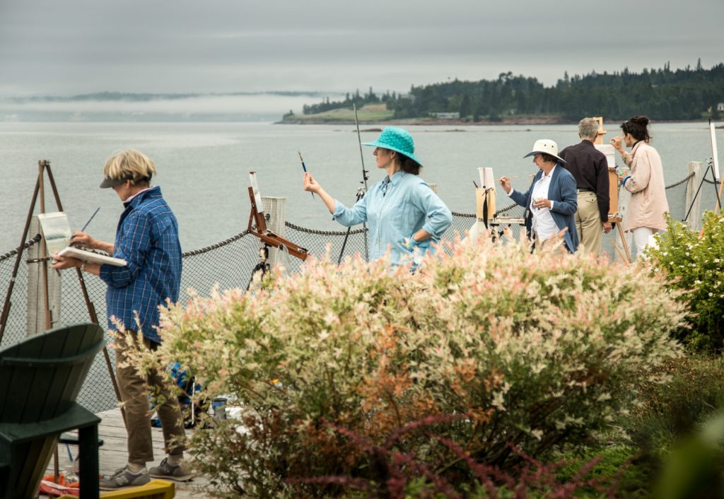 People painting along the windswept shores of Passamaquoddy Bay