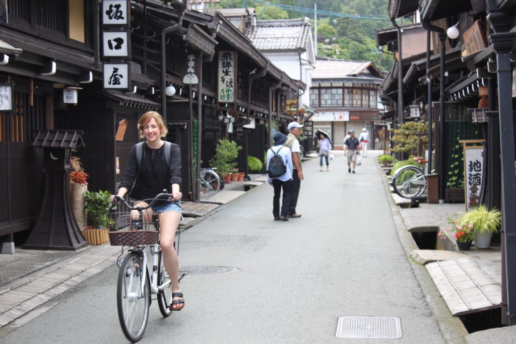 A girl cycling through Sanmachi Suji