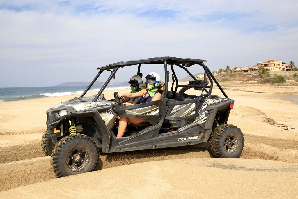 Two people driving a UTV in the California Outback