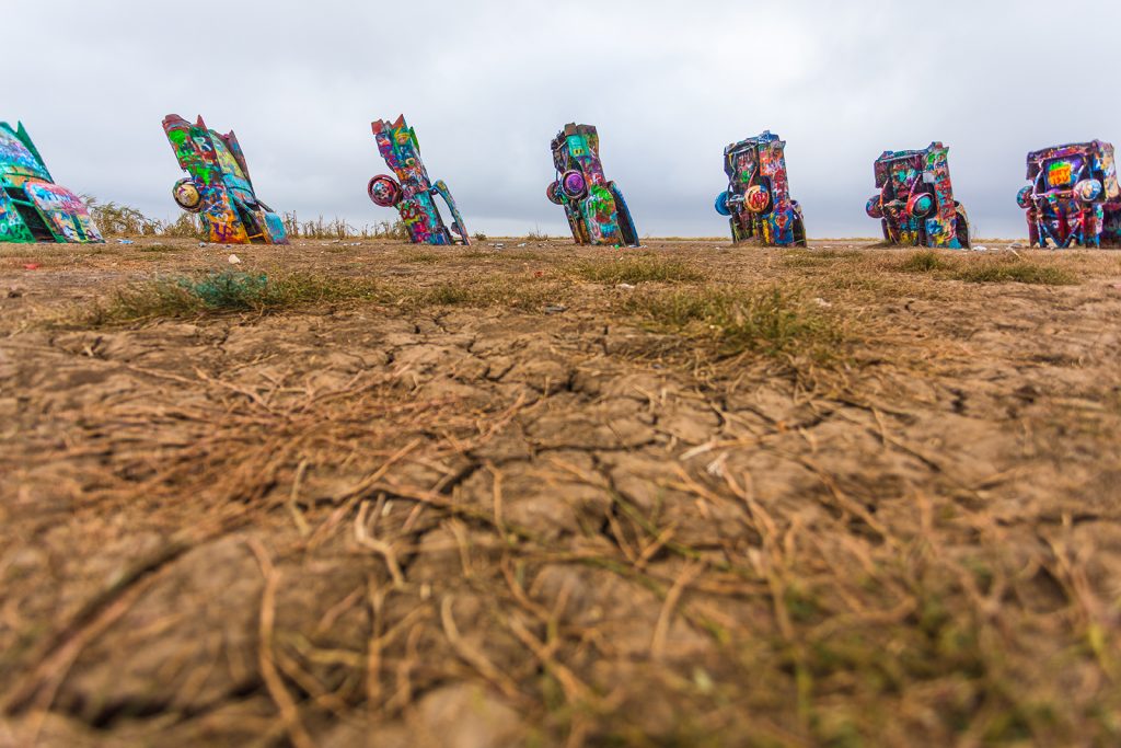 Cadillac Ranch, painted and colourful cars in the ground.