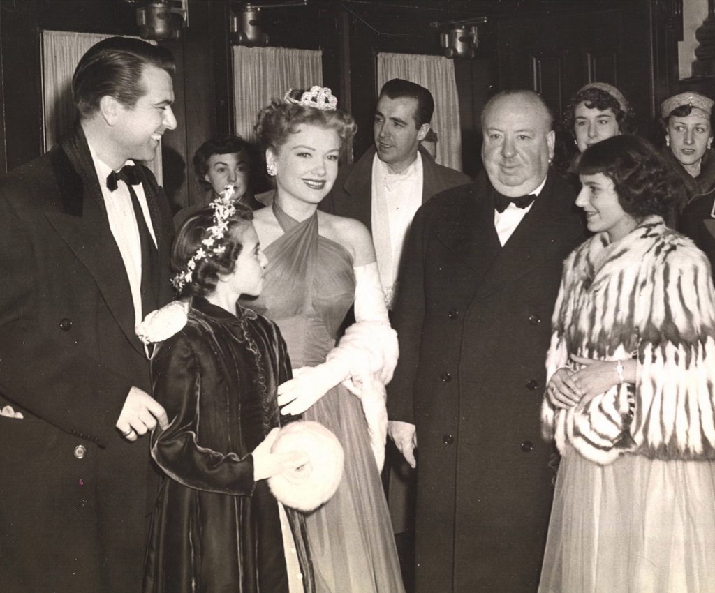 Director Alfred Hitchcock arrives at Quebec's Capitol Theatre for the premiere of his film I Confess, which was filmed on location in the city. Also pictured, left to right, are Roger Dann, Renée Hudon, Anne Baxter, and Carmen Gingras.