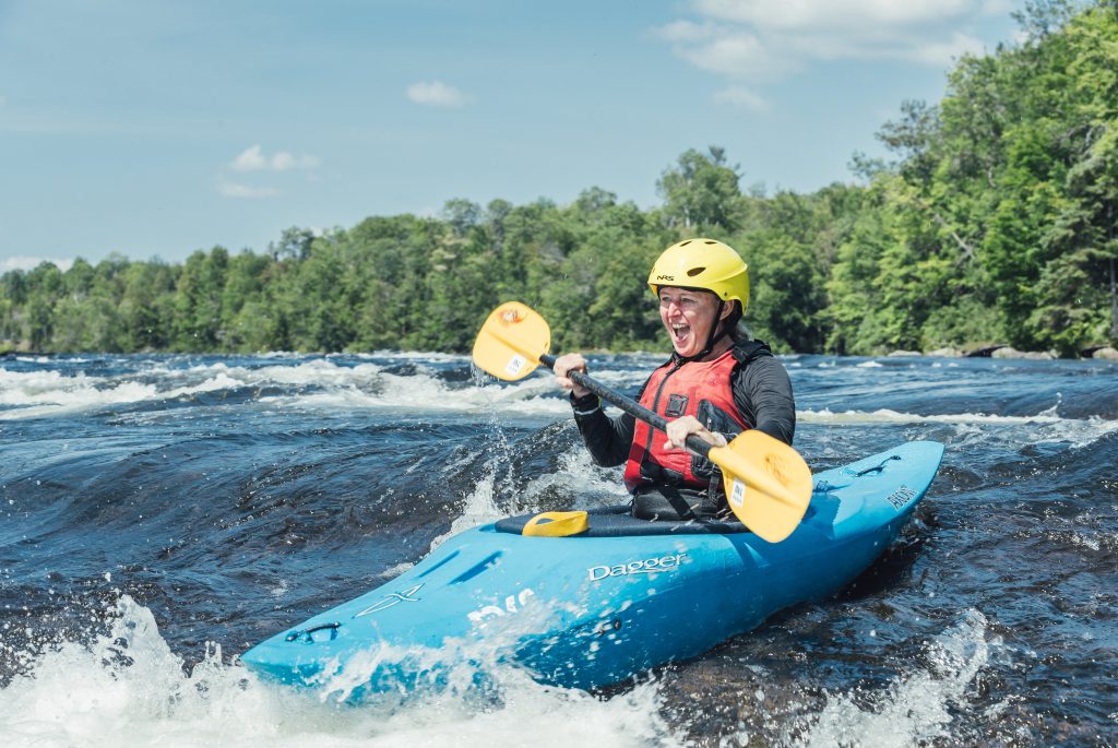 Woman kayaking on whitewater