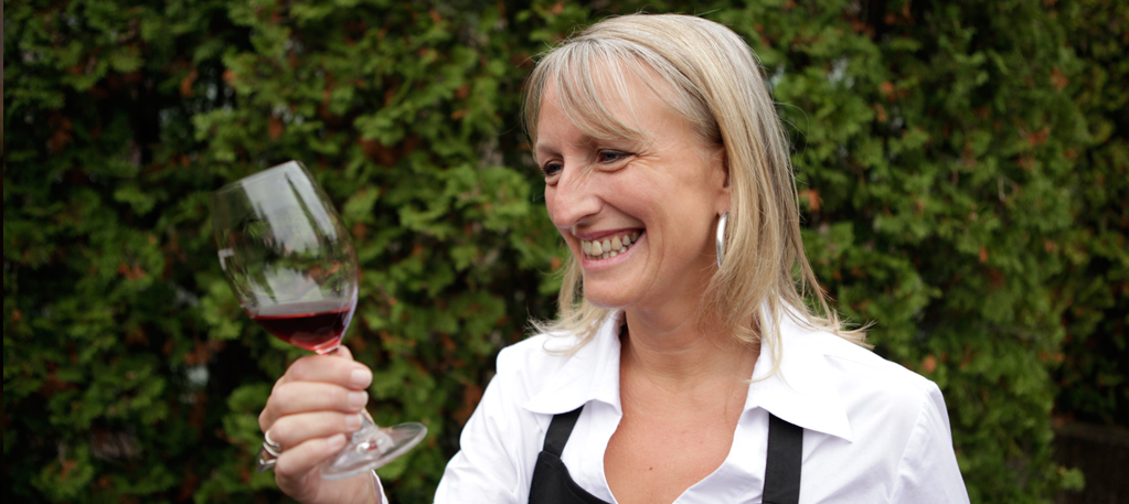 Veronique Rivest holding a glass of red wine