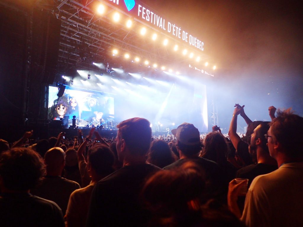 Music festival stage with crowds cheering