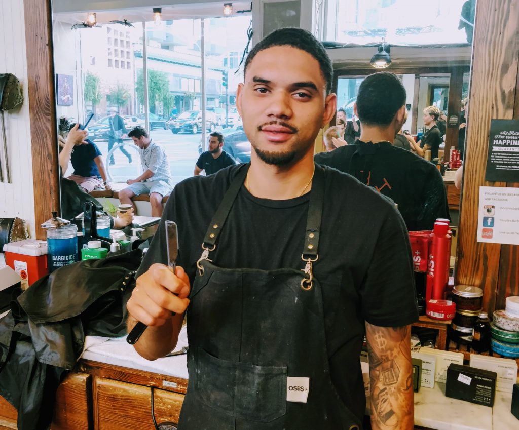 A barber holds a straight razor at Peoples Barber & Shop in San Francisco