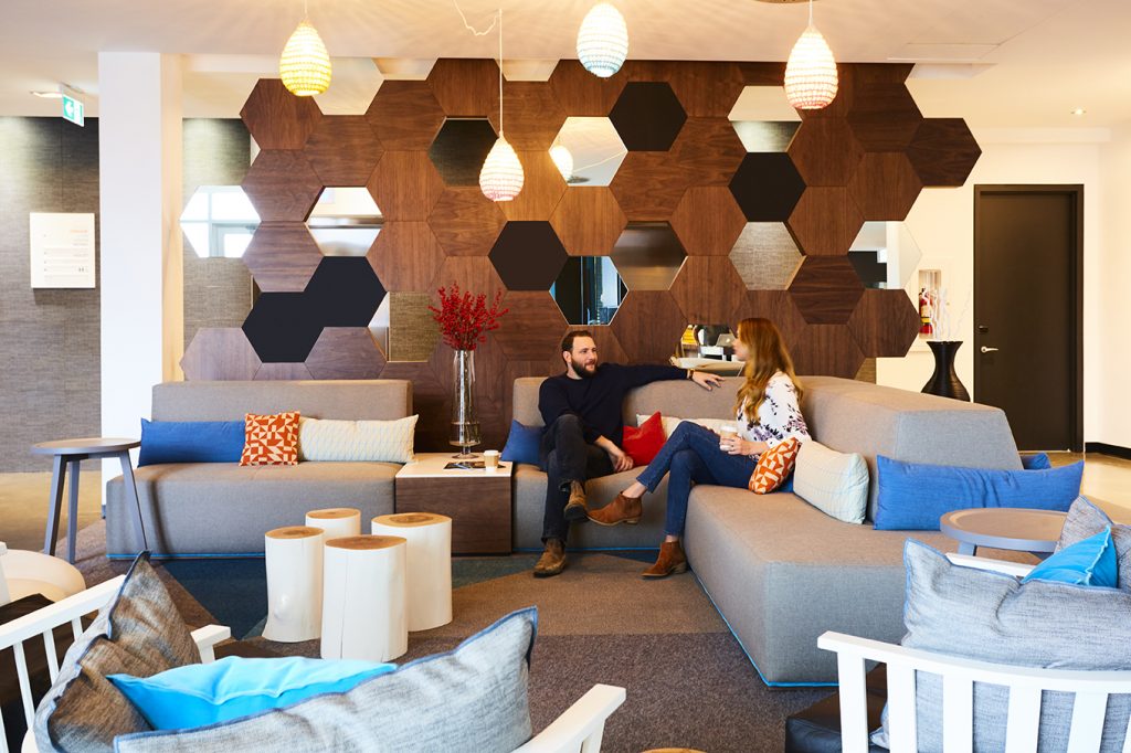 Cool hotel lobby with geometric panelling and sleek modern furniture