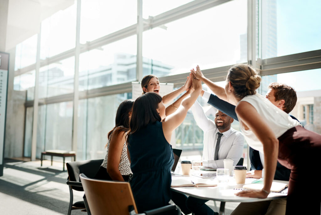 employees high five in office