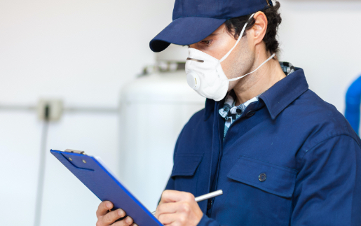 Man checking clipboard while wearing a mask