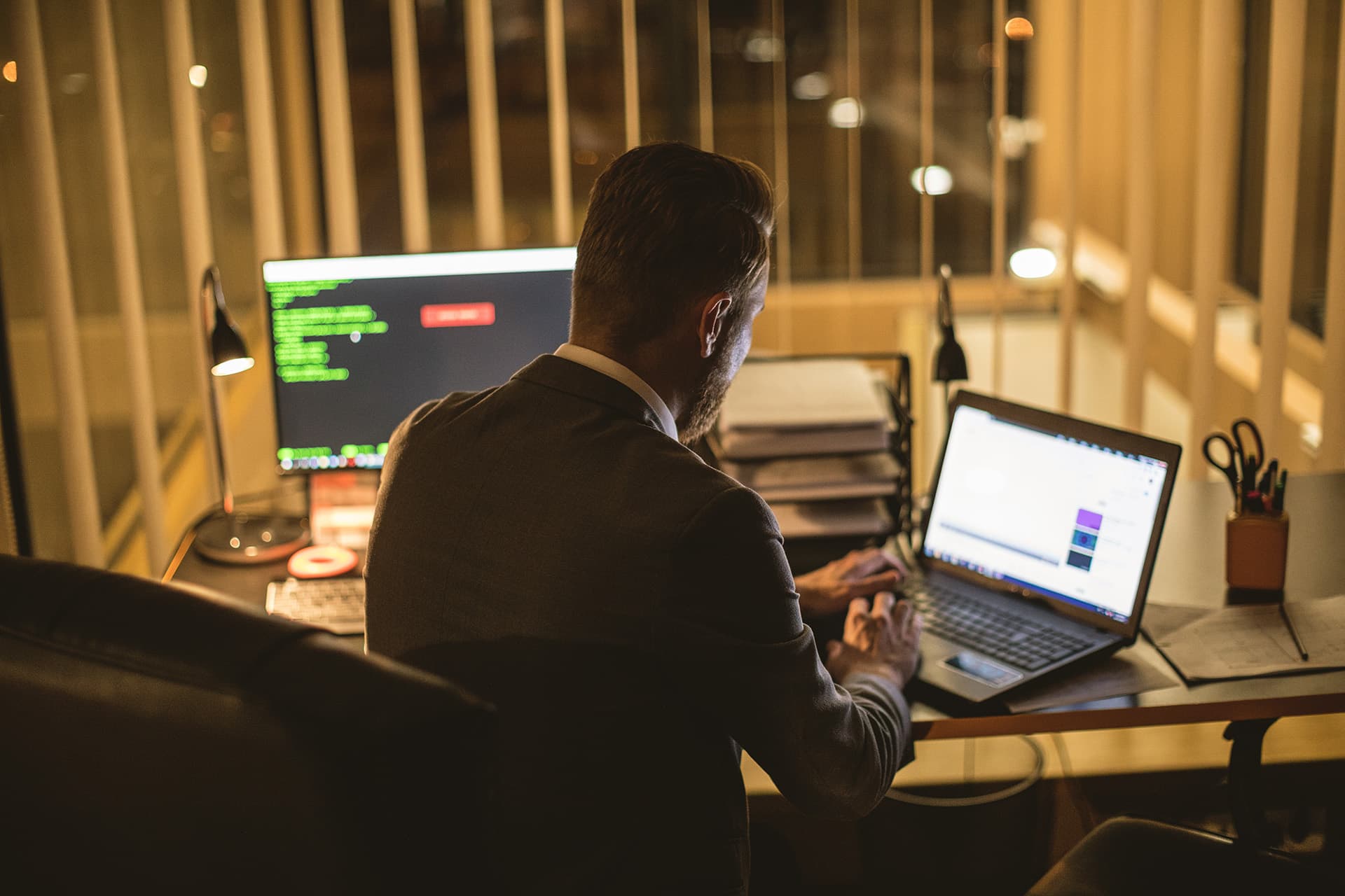 Man sitting at a desk looking at commercial property insurance on his laptop