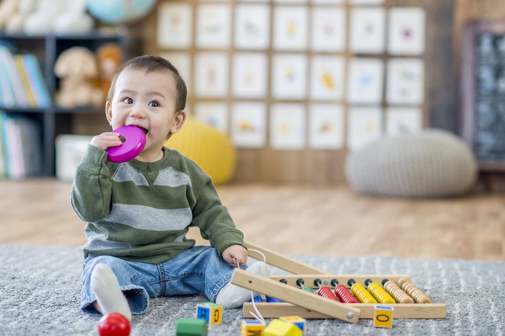 Baby playing at his daycare with childcare insurance