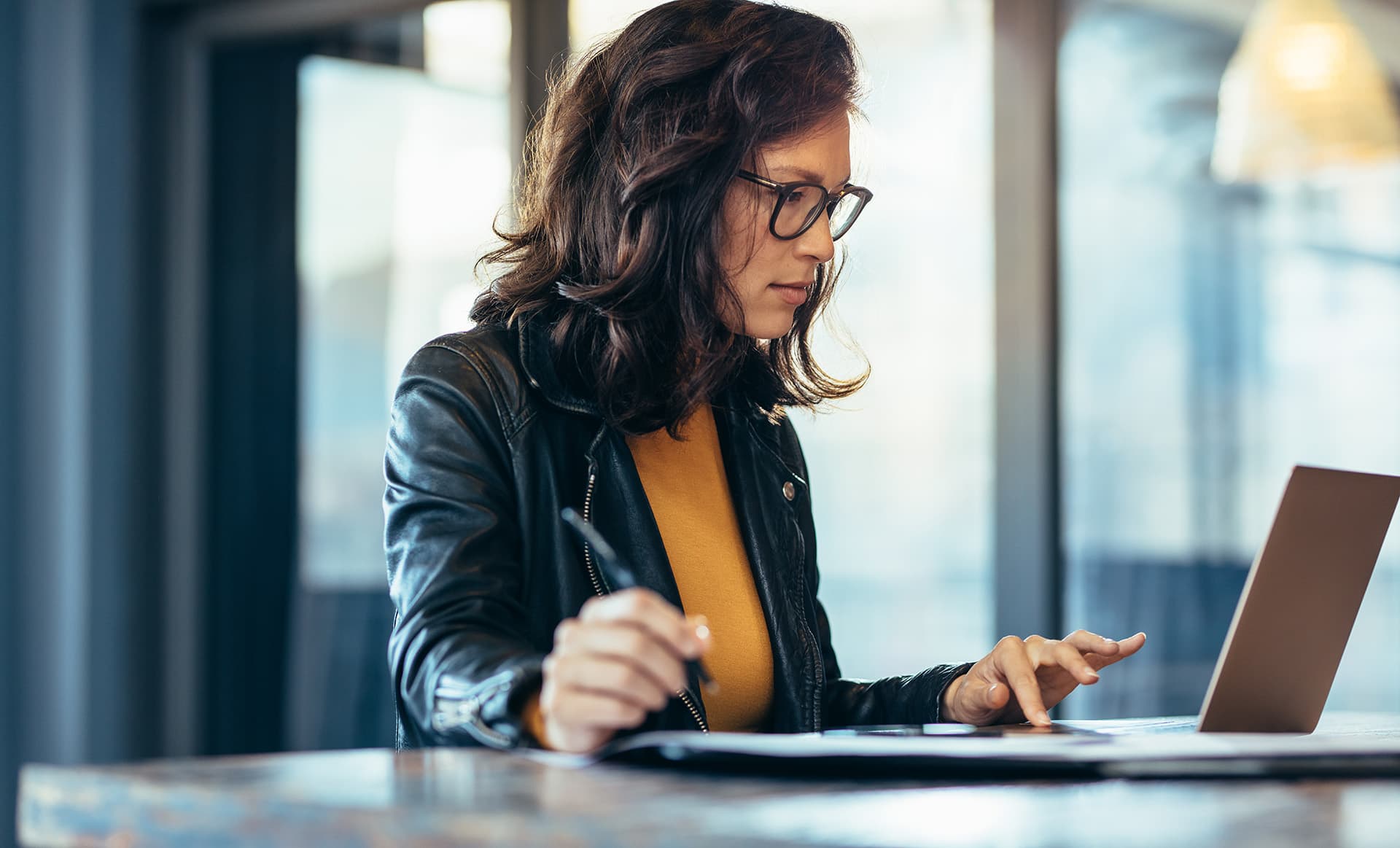 Student working on her laptop with student travel insurance