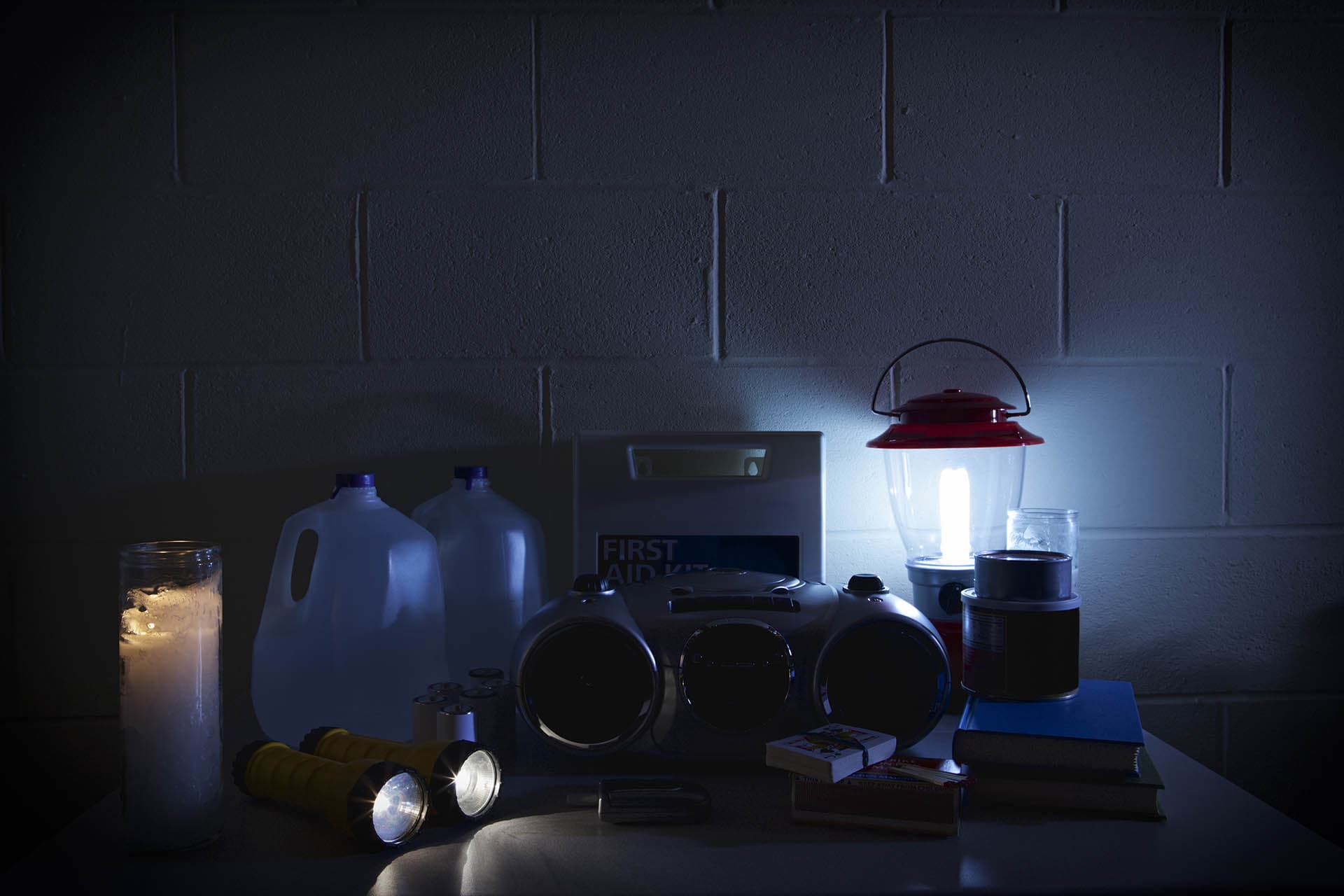 Supplemental insurance with emergency supplies including radio, water, flashlights, candles, playing cards