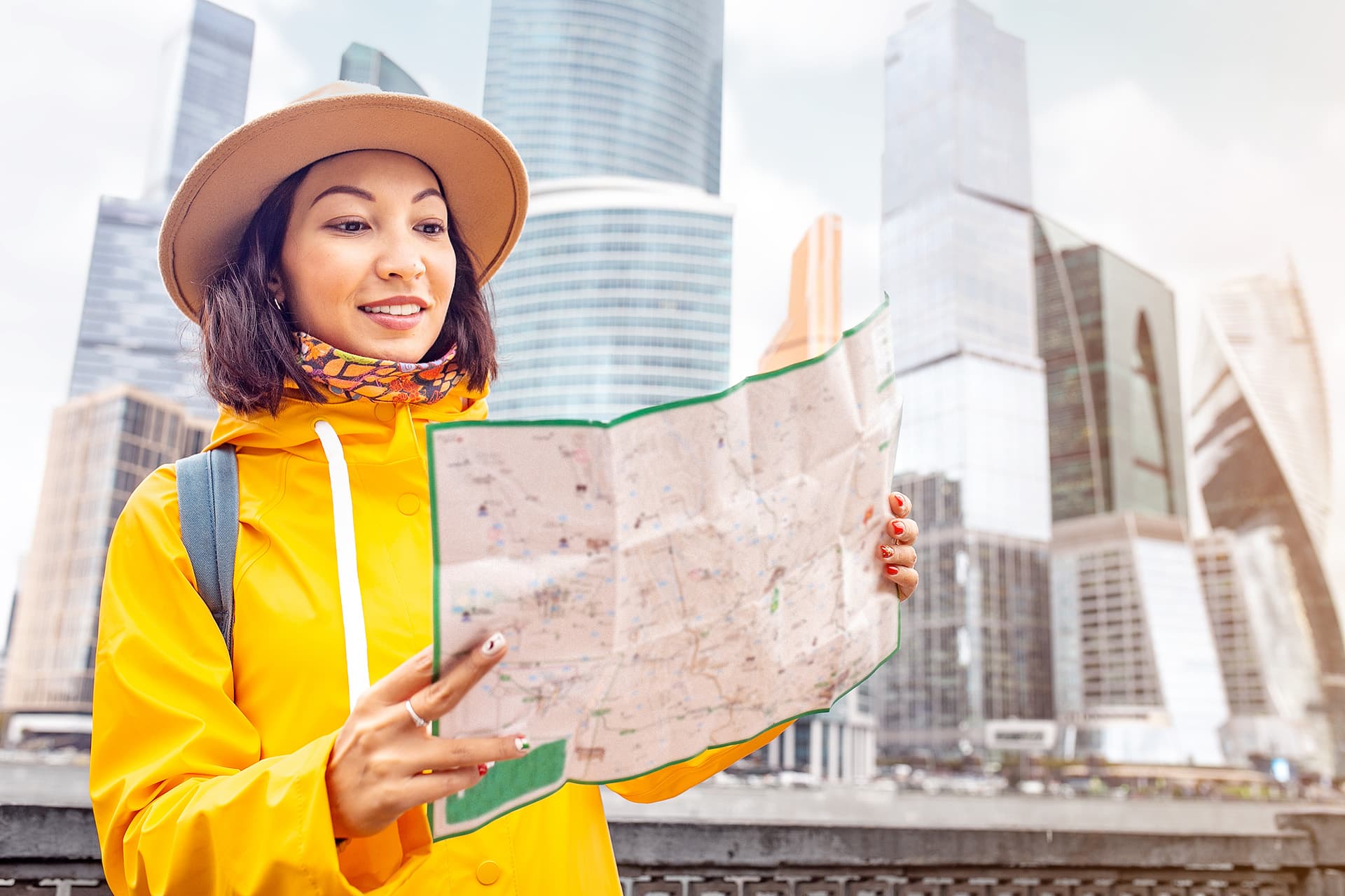 Canada visitor insurance for woman looking at a map in the city
