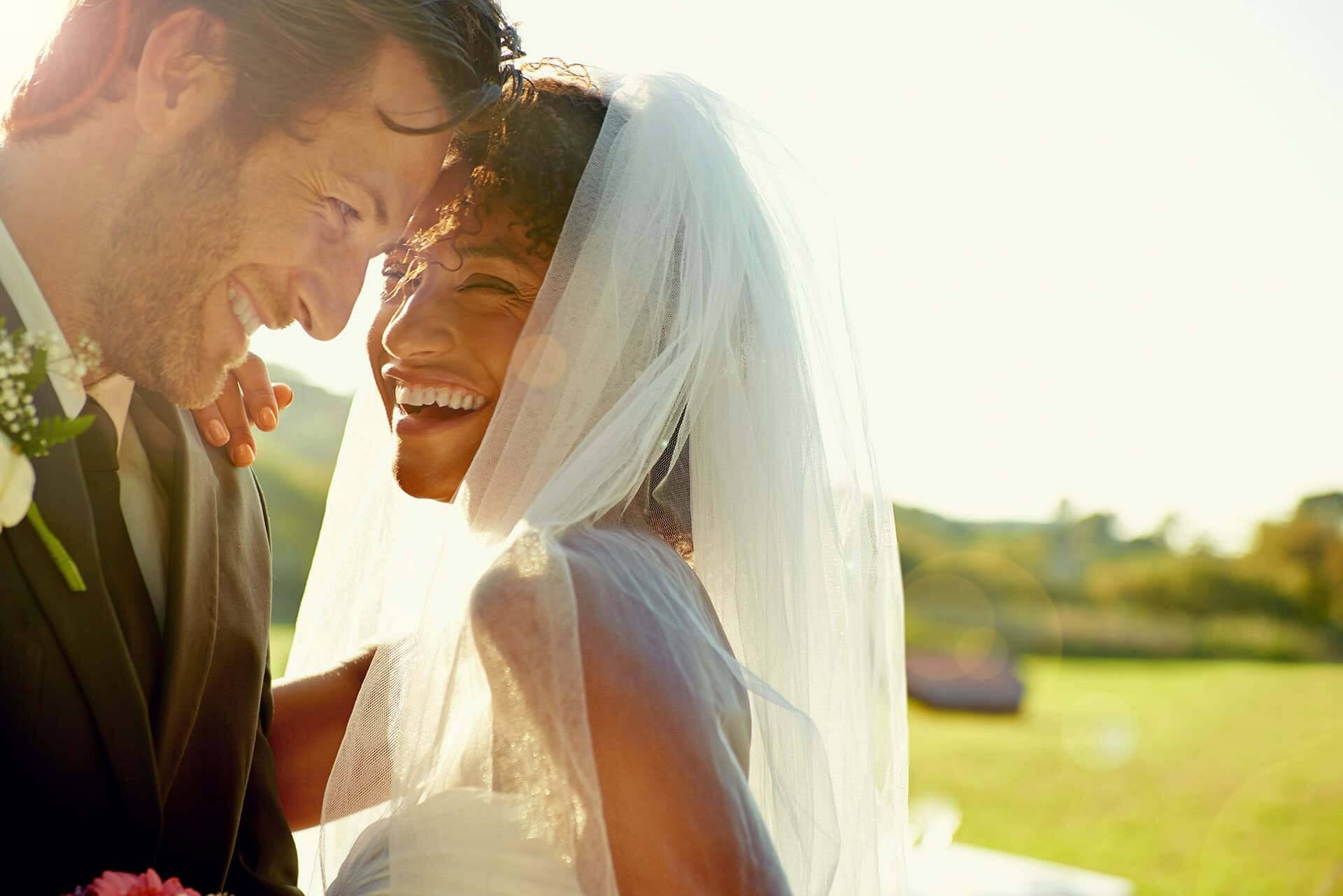 Life insurance for a bride and groom smiling and looking at each other
